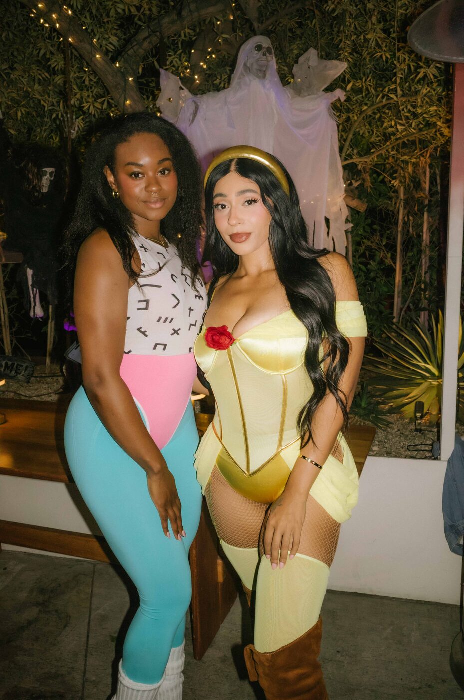 Two guests in 80s workout and Belle costumes